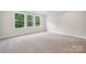 This spacious bedroom has carpeted floors and multiple windows that let in plenty of light at 9940 Manor Vista Trl, Kannapolis, NC 28027