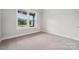 This cozy bedroom has a large window that lets in plenty of natural light at 9940 Manor Vista Trl, Kannapolis, NC 28027