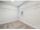 Walk-in closet with carpet and wire shelving for optimal organization at 9940 Manor Vista Trl, Kannapolis, NC 28027