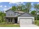 Charming two-story home featuring a stone facade, gray siding, and a two-car garage at 9940 Manor Vista Trl, Kannapolis, NC 28027