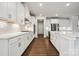 Bright kitchen featuring white cabinetry, stainless steel appliances, quartz countertops and hardwood floors at 9940 Manor Vista Trl, Kannapolis, NC 28027