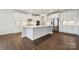 Modern kitchen featuring white cabinets, stainless steel appliances, and a central island at 9940 Manor Vista Trl, Kannapolis, NC 28027