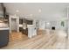 Open floor plan combining kitchen and living room with hardwood floors and natural light at 9940 Manor Vista Trl, Kannapolis, NC 28027