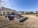 Spacious backyard with outdoor seating, a fire pit, and a brick planter box at 1022 Doughton Ln, Indian Trail, NC 28079