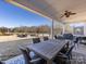 Outdoor covered patio with outdoor table and chairs, offering backyard views at 1022 Doughton Ln, Indian Trail, NC 28079