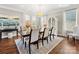 Elegant dining room with a large table, stylish chairs, hardwood floors, and natural light at 1022 Doughton Ln, Indian Trail, NC 28079