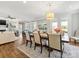 Open-concept dining area with natural light, wood floors, and a view into the living room at 1022 Doughton Ln, Indian Trail, NC 28079