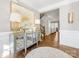 Spacious foyer with hardwood floors, a decorative rug, a stylish console table, and views of the staircase at 1022 Doughton Ln, Indian Trail, NC 28079