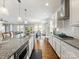Bright and open kitchen with granite countertops, stainless steel appliances, and a seamless flow to the dining area at 1022 Doughton Ln, Indian Trail, NC 28079
