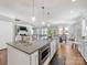 Open kitchen showcasing granite countertops, stainless steel appliances, and a view into the dining and living areas at 1022 Doughton Ln, Indian Trail, NC 28079