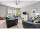 Spacious living room with comfortable seating, carpet, and a ceiling fan at 1022 Doughton Ln, Indian Trail, NC 28079