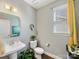 Stylish powder room with pedestal sink, modern fixtures, decorative mirror, and elegant finishes at 1022 Doughton Ln, Indian Trail, NC 28079