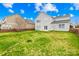 Fenced backyard featuring lush green grass and view of the home's back exterior at 10223 Kelso Ct, Charlotte, NC 28278