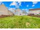 Sprawling backyard featuring a well-maintained lawn, surrounded by mature trees and neighboring homes at 10223 Kelso Ct, Charlotte, NC 28278