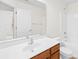 Bathroom with single sink vanity, and combined shower and tub with white tile surround at 10223 Kelso Ct, Charlotte, NC 28278