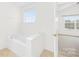 Bathroom features a bathtub and adjacent bedroom at 10223 Kelso Ct, Charlotte, NC 28278