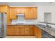 Well-equipped kitchen with granite countertops, wooden cabinets, and stainless steel appliances at 10223 Kelso Ct, Charlotte, NC 28278
