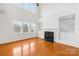 Spacious living room featuring hardwood floors, a fireplace, and built-in shelving at 10223 Kelso Ct, Charlotte, NC 28278