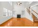 Bright living room with hardwood floors, a fireplace, and access to the staircase at 10223 Kelso Ct, Charlotte, NC 28278