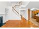 Spacious living room features hardwood floors, fireplace, and open staircase to the second floor at 10223 Kelso Ct, Charlotte, NC 28278