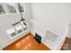 Bright living room with hardwood floors, ceiling fan, fireplace and many windows at 10223 Kelso Ct, Charlotte, NC 28278