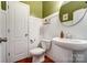 Bathroom showcasing pedestal sink, white wainscoting and green accent wall at 10321 Solar Way, Charlotte, NC 28278