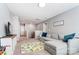 Spacious bonus room with a cozy sectional sofa, playroom rug, and staircase access at 10321 Solar Way, Charlotte, NC 28278