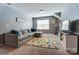 Inviting bonus room featuring a comfortable sofa, colorful rug, and entertainment center at 10321 Solar Way, Charlotte, NC 28278