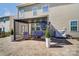The covered patio offers a relaxing outdoor seating area and a mounted television for entertainment at 10321 Solar Way, Charlotte, NC 28278