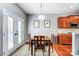 Bright dining room with French doors, hardwood floors, and adjacent kitchen view at 10321 Solar Way, Charlotte, NC 28278