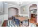 Charming dining room with a large wooden table set for a meal, complemented by decorative trim and natural light at 10321 Solar Way, Charlotte, NC 28278