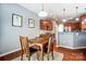 Dining area features hardwood floors, wood table, and adjacent kitchen space at 10321 Solar Way, Charlotte, NC 28278
