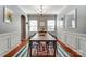 Formal dining room featuring decorative trim, a modern chandelier, and a striking rug under the large wooden table at 10321 Solar Way, Charlotte, NC 28278