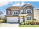 Charming two-story home featuring stone and siding accents, a two-car garage, and a well-maintained front yard at 10321 Solar Way, Charlotte, NC 28278
