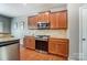 Stylish kitchen with stainless steel oven and microwave, granite countertops, and wood cabinets at 10321 Solar Way, Charlotte, NC 28278