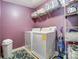 Functional laundry room featuring a washer, dryer, and ample storage shelves at 10321 Solar Way, Charlotte, NC 28278