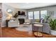 Inviting living room featuring a fireplace, ample seating, hardwood floors, and large windows for natural light at 10321 Solar Way, Charlotte, NC 28278