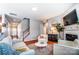 Bright living room with fireplace, staircase, white furniture, and hardwood floors at 10321 Solar Way, Charlotte, NC 28278