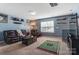 Large living room with comfortable furniture, sports decor, and a view of the window at 10321 Solar Way, Charlotte, NC 28278