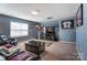 Living room area with a large TV, sports decor, and window light at 10321 Solar Way, Charlotte, NC 28278