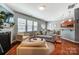 Inviting living room boasts natural light, hardwood floors, and fireplace adjacent to open kitchen at 10321 Solar Way, Charlotte, NC 28278
