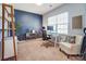 Bright home office with a large window, neutral carpet, contemporary furnishings, and a stylish accent wall at 10321 Solar Way, Charlotte, NC 28278