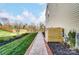 A stone paver walkway leads to the side yard with manicured lawn and utility box at 10321 Solar Way, Charlotte, NC 28278