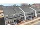 Birds-eye view of newly built townhomes featuring gray exteriors, well-kept grounds, and an inviting community layout at 104 Ciara Pl # B, Mooresville, NC 28117