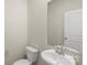Clean bathroom with white toilet and sink and large mirror at 104 Ciara Pl # B, Mooresville, NC 28117