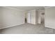 Open bedroom with neutral paint and carpet features easy access to other rooms at 104 Ciara Pl # B, Mooresville, NC 28117