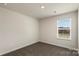 Carpeted bedroom featuring a window with white blinds and neutral paint at 104 Ciara Pl # B, Mooresville, NC 28117