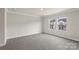 Bedroom features neutral carpet and a view of the neighboring homes at 104 Ciara Pl # B, Mooresville, NC 28117