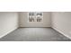 Bedroom features neutral carpet and a view of the neighboring homes at 104 Ciara Pl # B, Mooresville, NC 28117