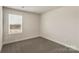 Neutral bedroom featuring carpet, a window, and electrical outlets at 104 Ciara Pl # B, Mooresville, NC 28117